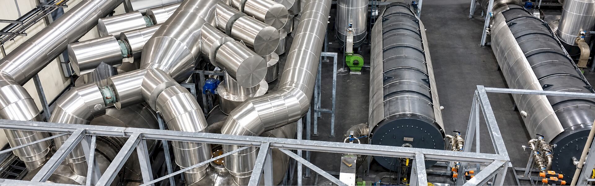 Stainless-steel pipework and processing equipment inside the Reoil tire pyrolysis plant in Poland, technology owned by Klean Industries Inc..